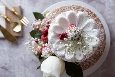 White cake Decorated with flower and berries. For celebrate party.の写真素材
