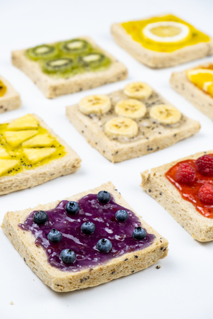 Delicious colourful minimal mix fruits jam on sliced bread.の写真素材