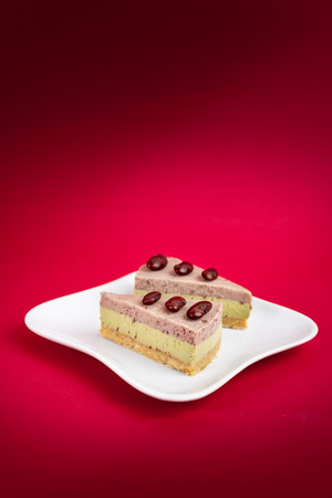 Sliced of Red bean cheese cake on white plate.の写真素材