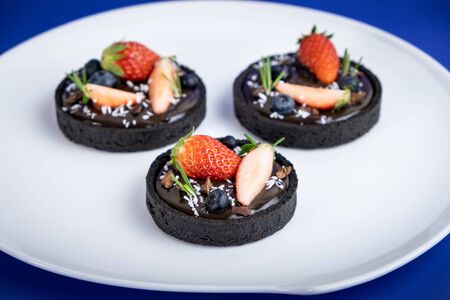 Cookie crust chocolate tart with Blueberry and strawberry.