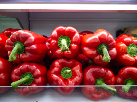 Red Bell peppers (capsicum) on supermarket shelf.の写真素材