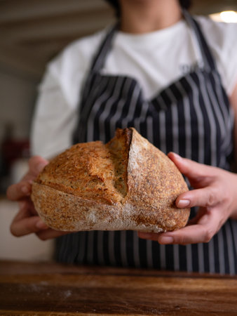 Artisan Sourdough Bread in Hand â€“ Fresh from the Oven.