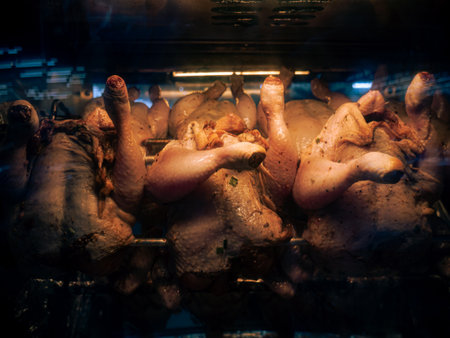 Stack of grilled chicken in steamy rotisserie oven machine.の写真素材