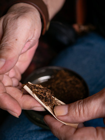 Preparing rolled cigarettes with dried tobacco.の写真素材