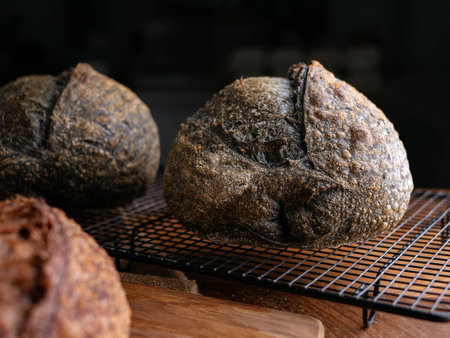 loaf of fresh baked black charcoal sourdough bread. Black ciabatta bread with activated carbon
