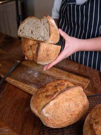 Bakerâ€™s Hand Presenting Homemade Sourdough.