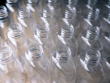 Close up Row of plastic drink water bottlesÂ for filling process.の写真素材