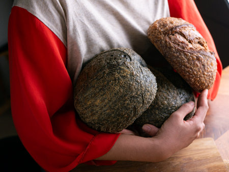 Woman hand hold fresh baked sourdough bread. Presenting Homemade ciabatta bread