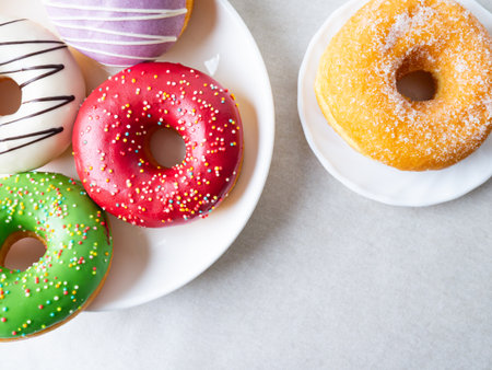 Donuts with colorful icing glazed designs on a white background. Copy free spaceの写真素材