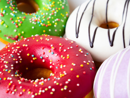 Donuts with colorful icing glazed designs on a white background. Copy free spaceの写真素材