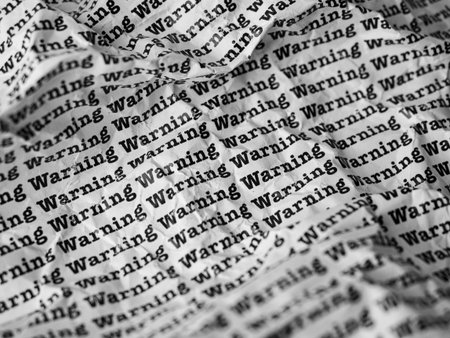 Words Warning Seamless print on crumpled paper for business background.の写真素材