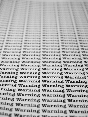 Words Warning Seamless print on paper for business background.の写真素材