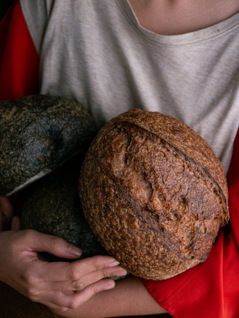 Woman hand hold fresh baked sourdough bread. Presenting Homemade ciabatta bread