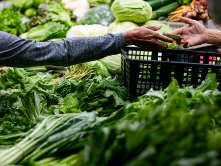 Customer Paying money for Fresh Vegetables at Market Stall.の写真素材