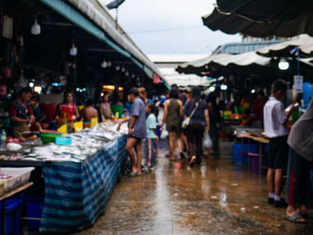 Blurred View of Local Market with Fresh Fish Stall and Shoppers.の写真素材