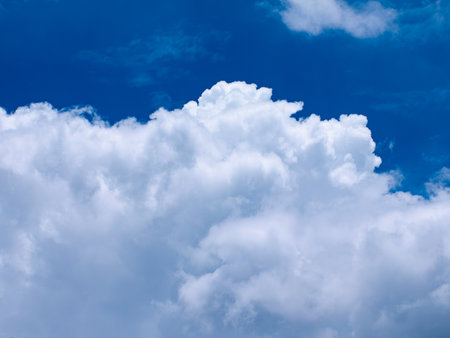 Beautiful dramatic deep blue sky with large fluffy white clouds on bright sunny day - perfect...
