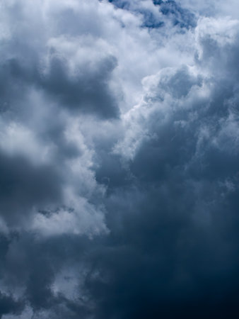 Dramatic dark storm clouds in overcast sky before thunderstorm and heavy rain - moody weather background for climate and meteorology concepts.の写真素材