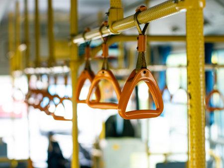 Passenger handholds and grab bars inside public transportation bus or train - safety support handles for commuters in urban transit vehicle.の写真素材