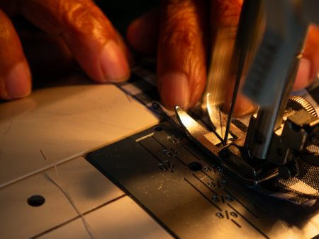 Senior Woman Working with Sewing Machine. Elderly Hands Creating Garments through Skilled Labor