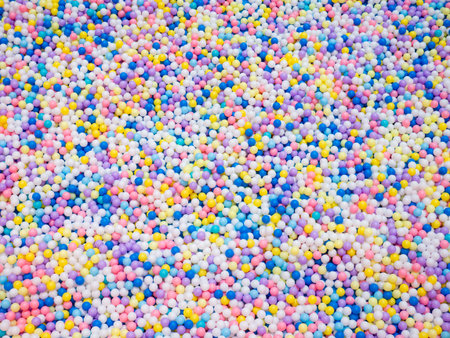 colorful ball pit with thousands of multicolored plastic balls at indoor playground entertainment...