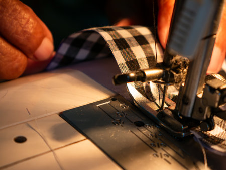 Senior Woman Working with Sewing Machine. Elderly Hands Creating Garments through Skilled Laborの写真素材