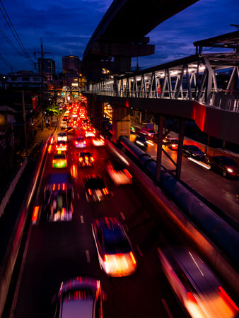 Traffic Light Trails at Twilight from Pedestrian Bridge - Urban Rush Hour with Motion Blur and City Skylineの写真素材