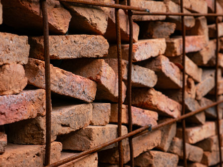 Stacked Red Clay Bricks in Construction Site - Traditional Building Materials Organized in Storage Rows for Architecture Project.の写真素材