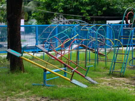 Colorful Vintage Playground Equipment in Public Park - Old Metal Playground Structures with Climbing Frames and Play Areaの写真素材