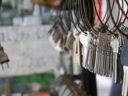 Multiple Duplicate Keys Hanging on Wire Rings at Locksmith Shop - Key Cutting and Duplication Service Businessの写真素材