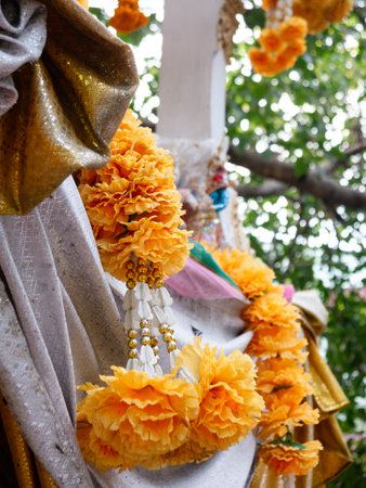 Vibrant Orange Marigold Flower Garlands at Hindu Buddhist Temple Shrine - Traditional Religious Offering Close-Upの写真素材