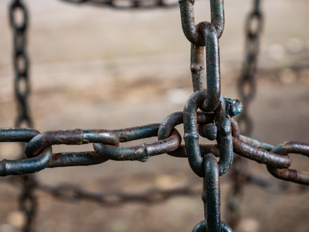 Close up of old rusty metal chain links with corrosion and weathered surface texture showing age and deteriorationの写真素材