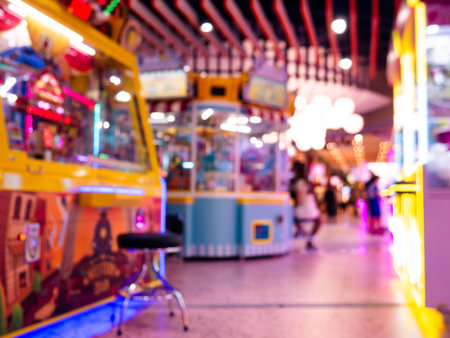 Blurred Defocused Arcade Game Center with Colorful Neon Lights and People Walking in Entertainment...