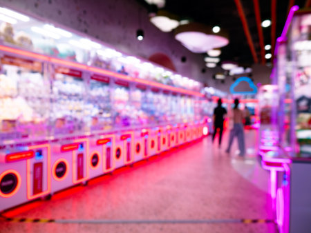 Abstract Defocused View of Entertainment Arcade Center with Glowing Gaming Cabinets and Moving Visitorsの写真素材