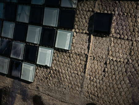 Old dirty cracked glass block tiles in black and white checkered pattern with scratches and deteriorationの写真素材
