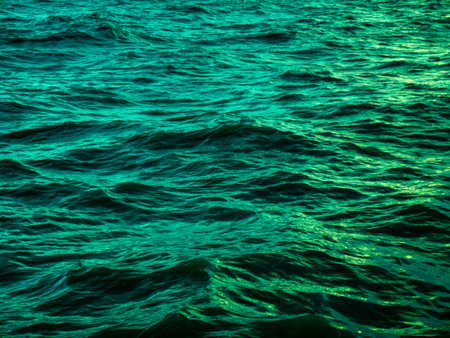 Turquoise Green Ocean Water Waves Surface with Golden Light Reflection - Tropical Sea Texture Background Patternの写真素材