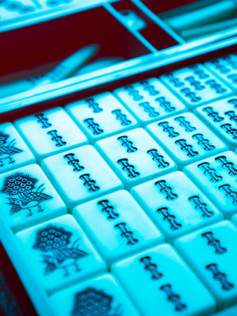 Chinese Mahjong Game Pieces Illuminated in Cyan Neon Lighting Showing Suo Bamboo Pattern