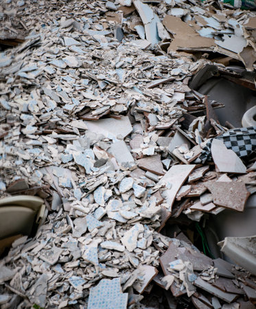 Close-up of Mixed Construction Waste Including Tiles Wood and Gypsum Boardの写真素材