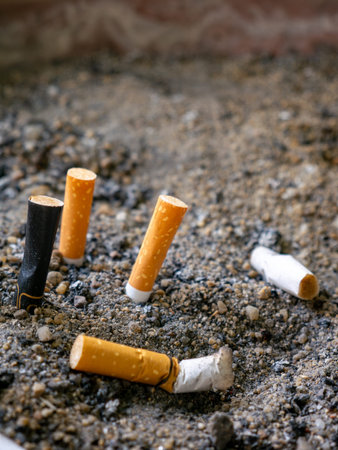 Used Cigarette Butts in Ashtray with Sand Smoking and Health Conceptの写真素材