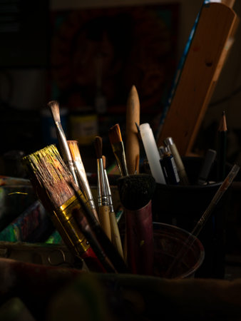 Artist Studio Workspace with Easel Paint Palette and Various Brushes