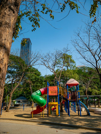 Colorful children playground equipment with spiral slide tunnel and climbing structure in urban park...