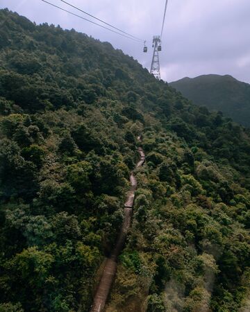 Cableway and road through the jungle in Hong Kongの写真素材