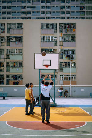 Hong Kong, China; Dic 9 2017: Adults and kids playing in colorful basketball courtのeditorial素材
