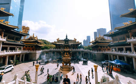 Shanghai, China; Nov 28 2017: Traditional chinese buddhist temple square with people praying and...