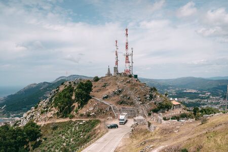 Telecom antenas on top of the hill at seaside in northern spainの写真素材