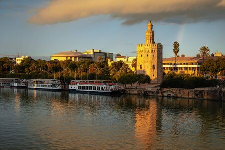 Beautiful tower of gold and Guadalquivir river at sunset in Seville, Spainの写真素材