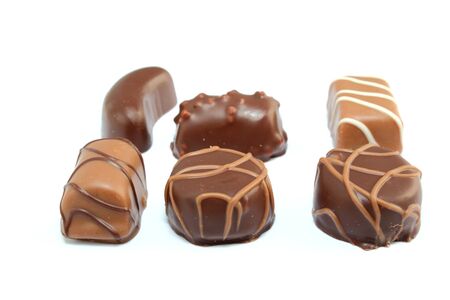 six different types of chocolate candies isolated on whiteの写真素材