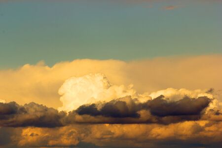 storm clouds illuminated by the setting sun at duskの写真素材