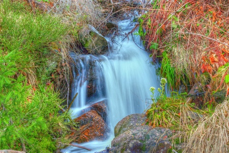beautiful waterfall from melting snow up in the mountains in springの写真素材