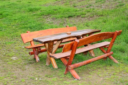 outdoor wooden bench near a lodge in the mountainsの写真素材