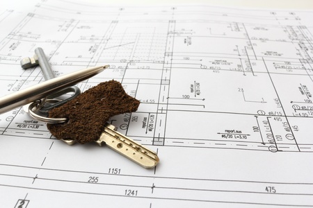 keys and pen over blueprint of house for contractの写真素材